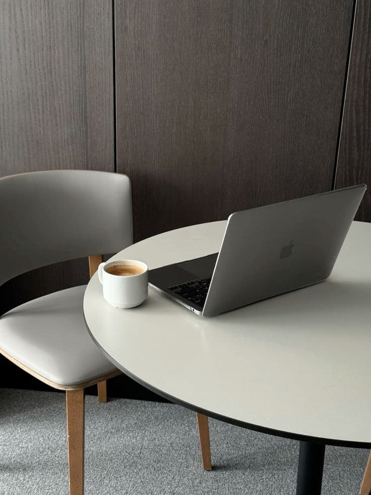 Collectiv studio workspace with laptop and coffee